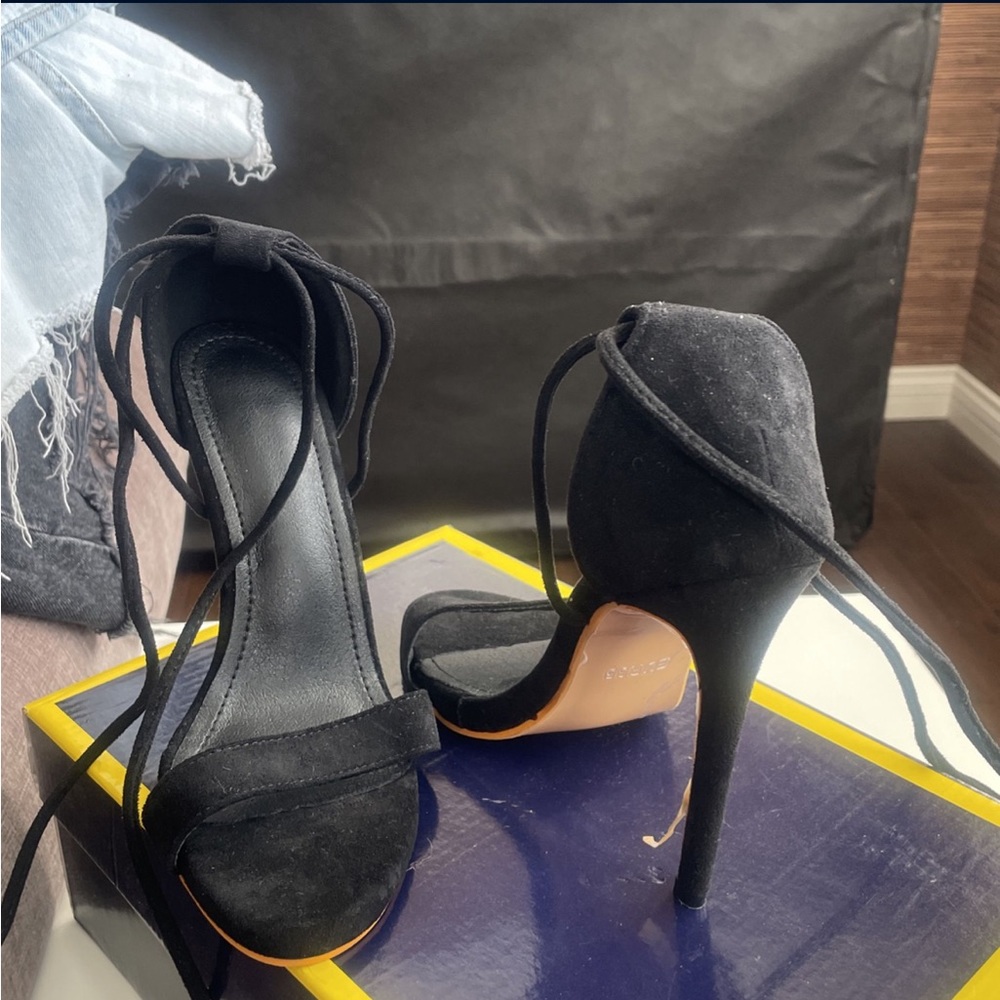 All black suede stilettos with laces that wrap around ankle or legs. Size 5.